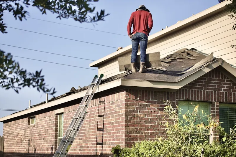 Professional roofer working on a residential roof in Llanerch
